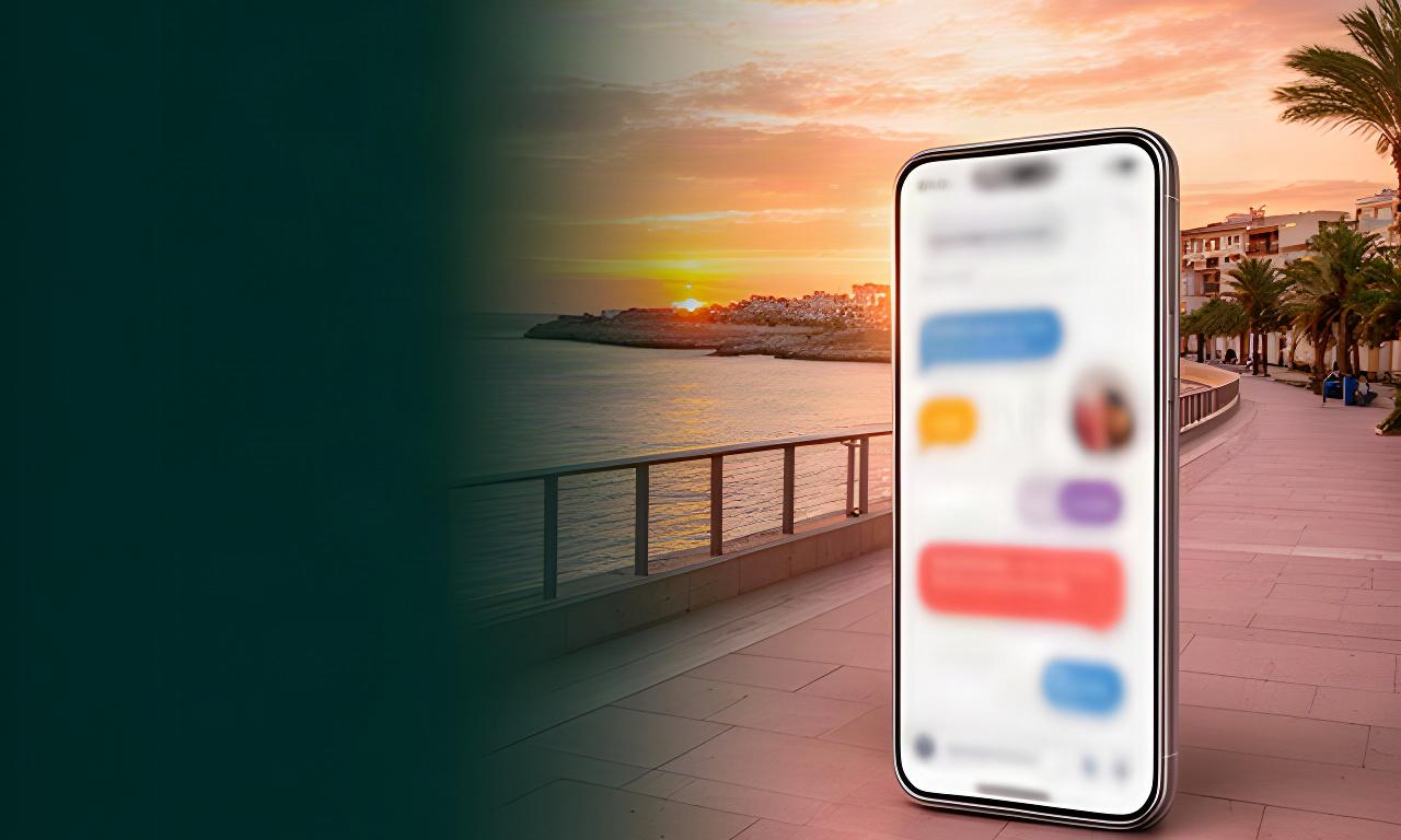 Paseo marítimo de Vinaròs al atardecer junto a un móvil con una conversación de atención al cliente